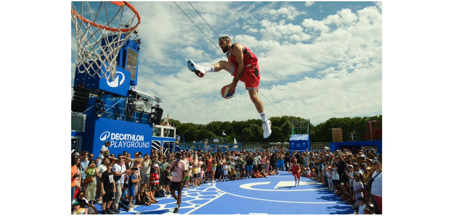 Player jumps with basketball at the Decathlon Playground at the Paris games.
