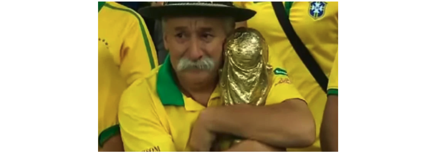 Fan holds onto replica World Cup trophy and cries.