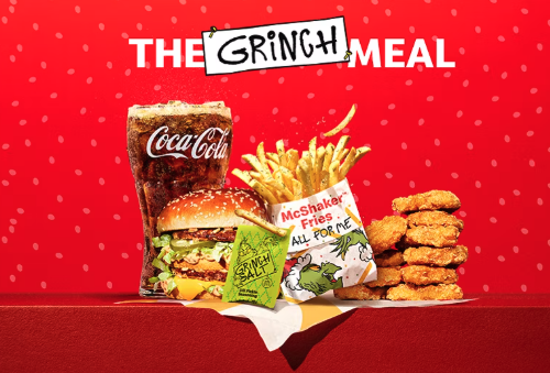 Image of McDonald's Grinch meal  burger with fries and chicken nuggets, with Grinch salt package on a red background 