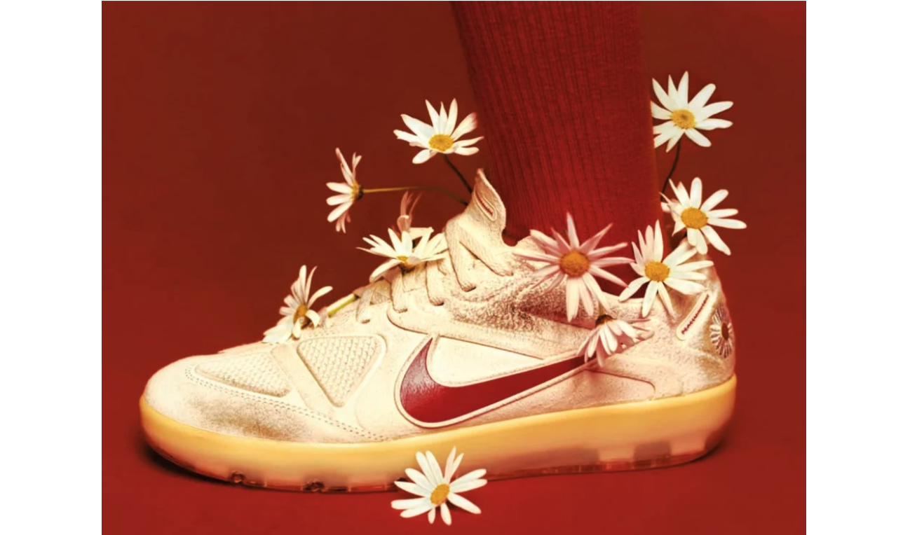 Nike Cryoshot sneaker for the PEACEMINUSONE x Korea x Nike Football Collection sits surrounded by daisies. 