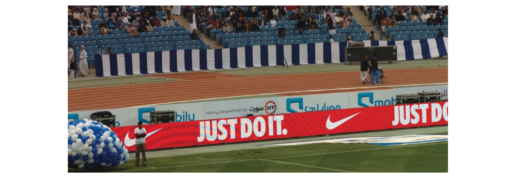 Perimeter board at football match shows Nike branding